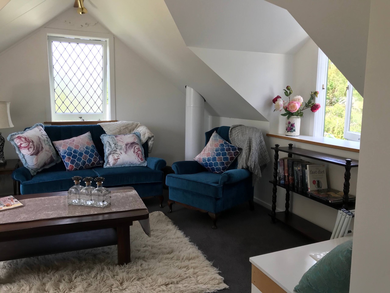 The sitting area with teal velvet sofa and armchairs